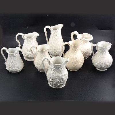 Lot 61 - Eight assorted Victorian Parian relief-moulded  jugs