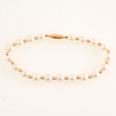 Lot 235 - Cultured pearl and gold bracelet, new and boxed.