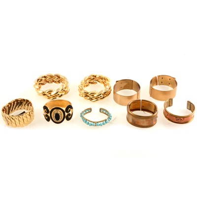 Lot 303 - Kigu, Ungaro and other vintage gilt metal hinged bracelets.