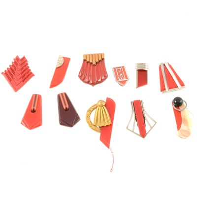 Lot 186 - Art Deco bakelite and celluloid dress clips in red tones.