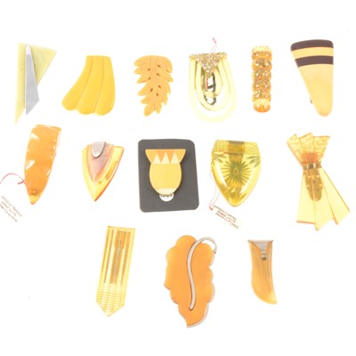 Lot 199 - Vintage lucite and celluloid dress clips and pins in yellow and pale orange tones.
