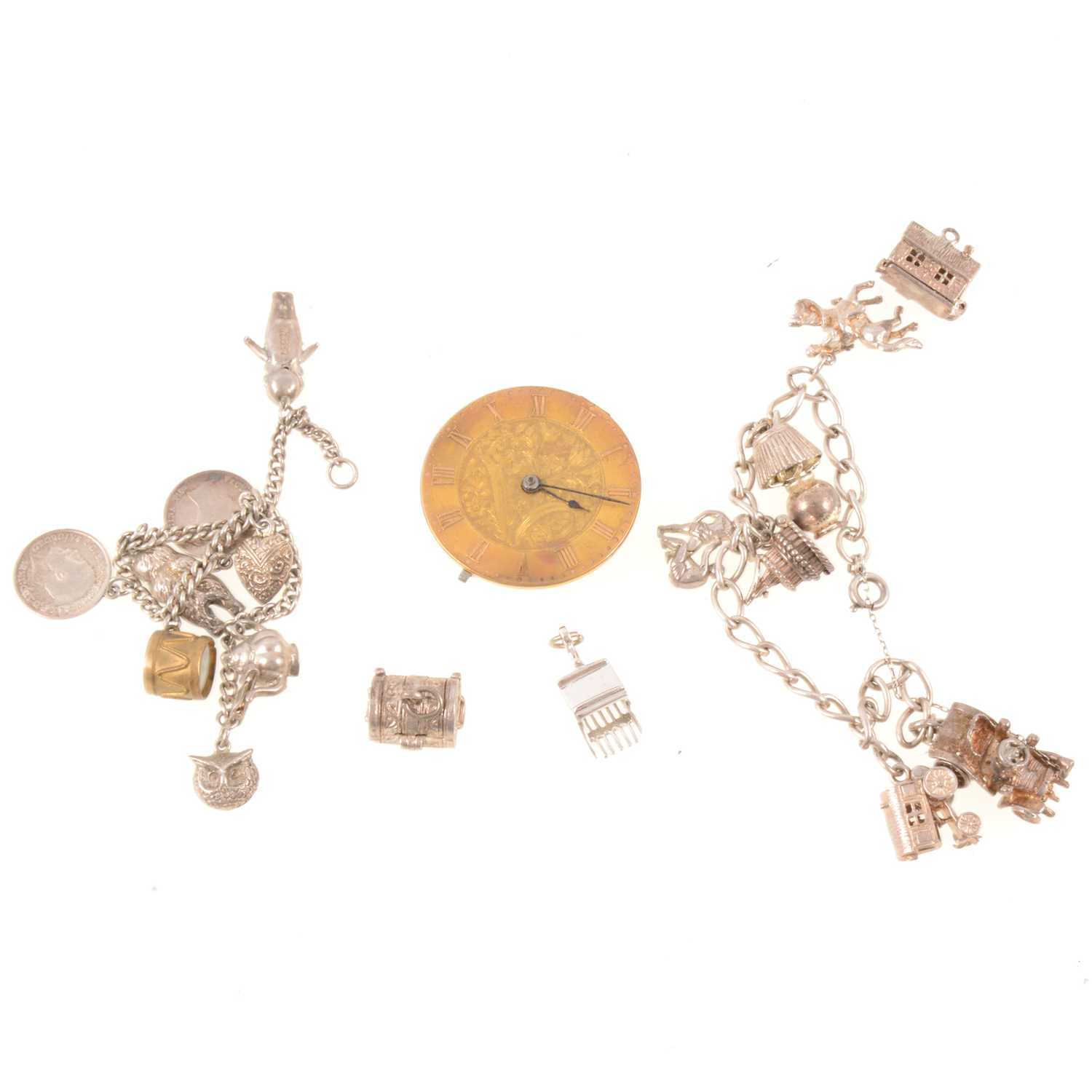 Lot 146 - White metal charm bracelet, other metal charms and a pocket watch mechanism.