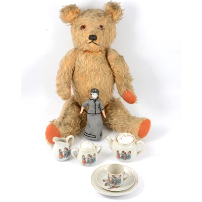 Lot 287 - A mid-20th century mohair teddy bear, miniature doll and tea set.