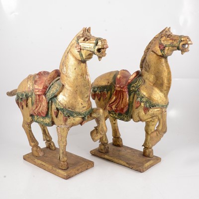 Lot 69 - Pair of Chinese carved and gold painted wood models of Tang horses