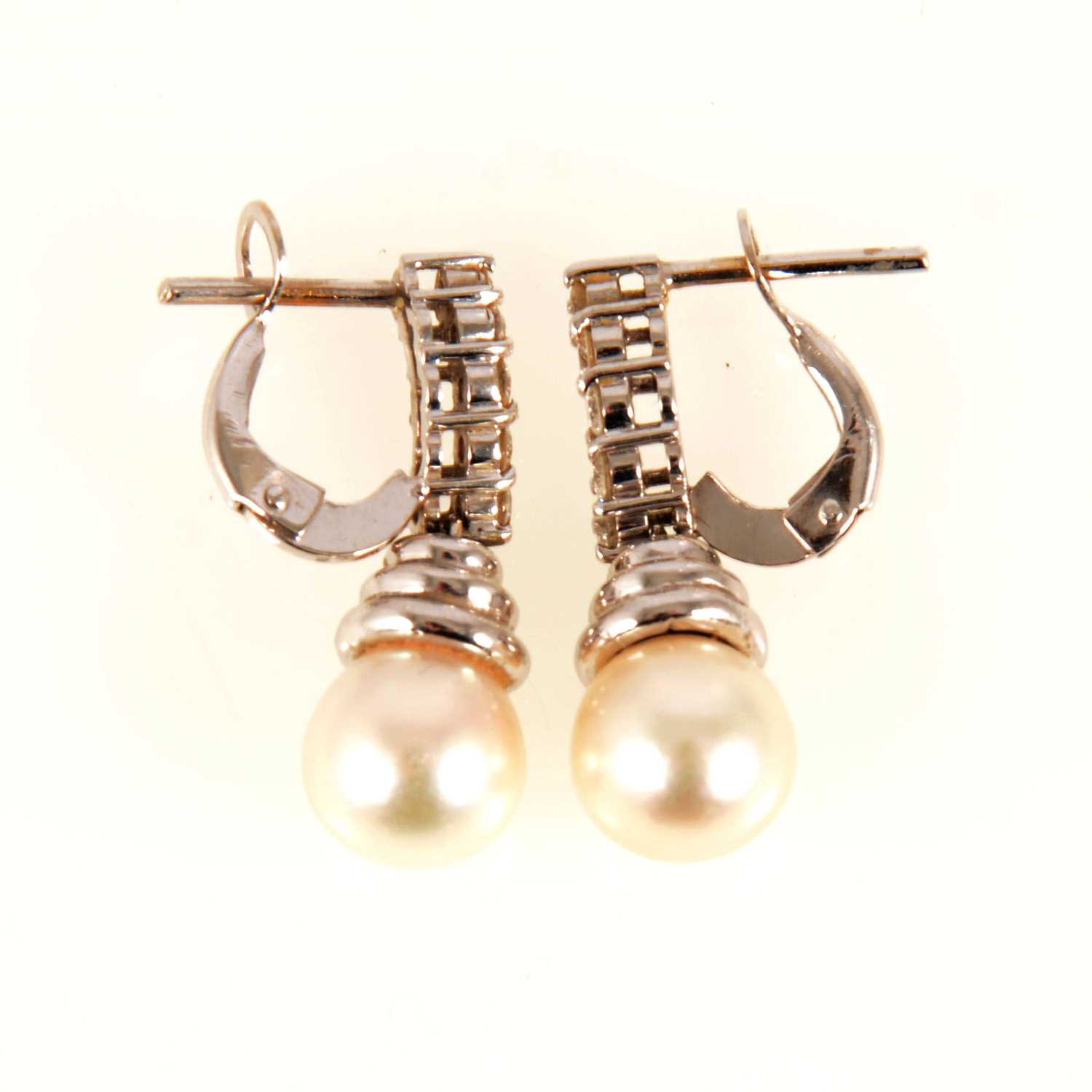 Lot 83 - A pair of pearl and diamond drop earrings.