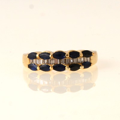 Lot 71 - A sapphire and diamond eternity ring.
