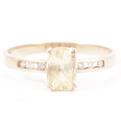Lot 162 - Natural yellow sapphire and diamond ring.