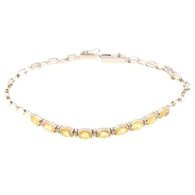 Lot 164 - Natural yellow sapphire and diamond bracelet.