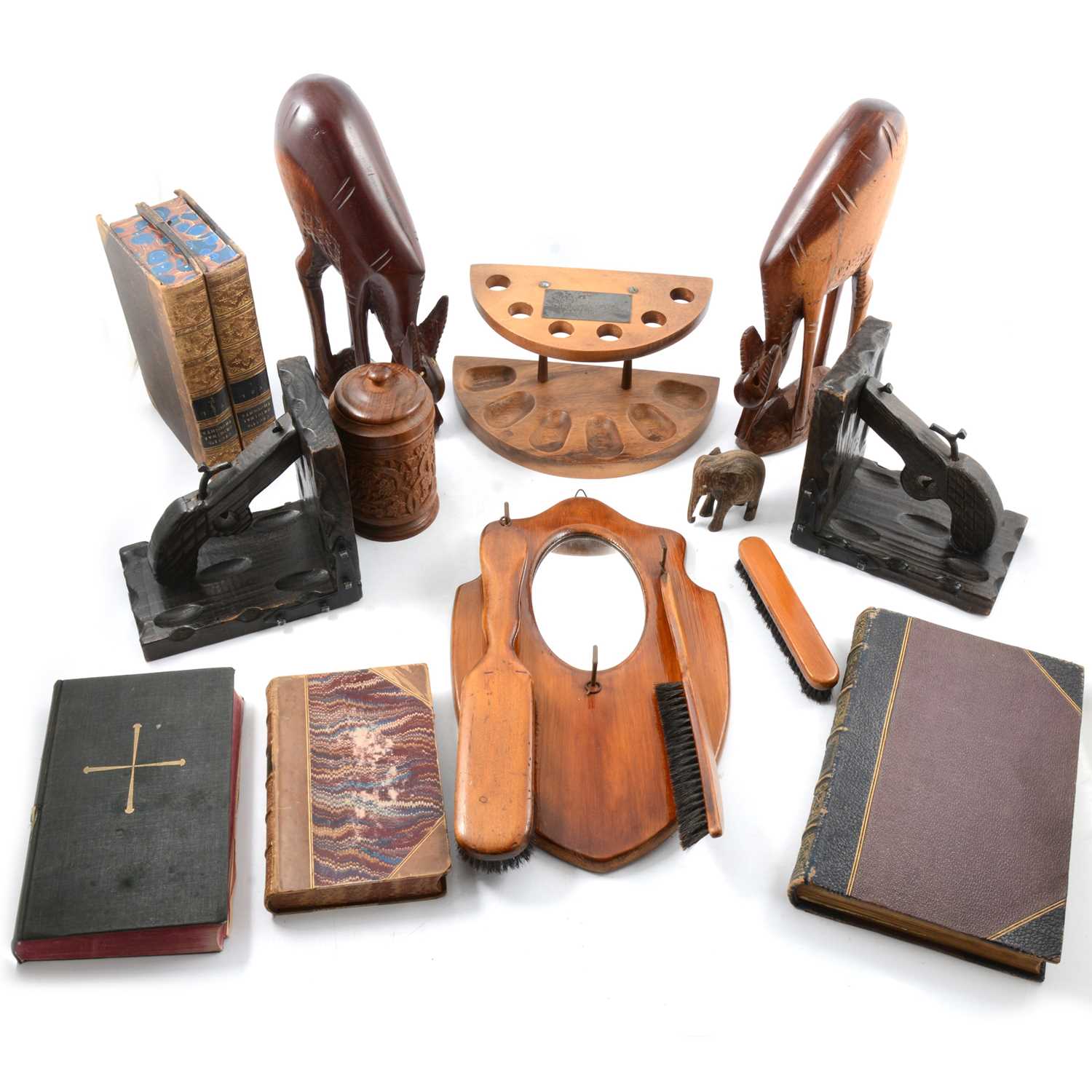 Lot 100 - Wooden 'pistol' bookends, hanging mirror and brush set, and other wooden items and books.