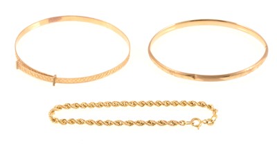 Lot 304 - Two 9 carat gold bangles and a rope bracelet.