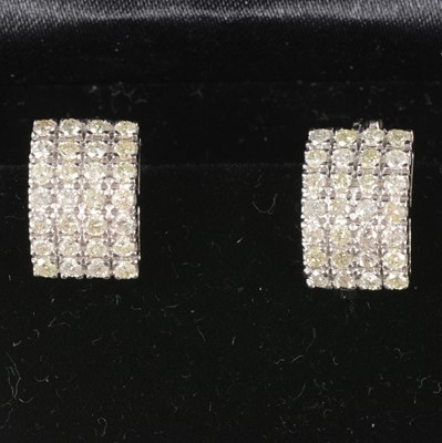 Lot 81 - A pair of multi stone diamond hoop earrings.