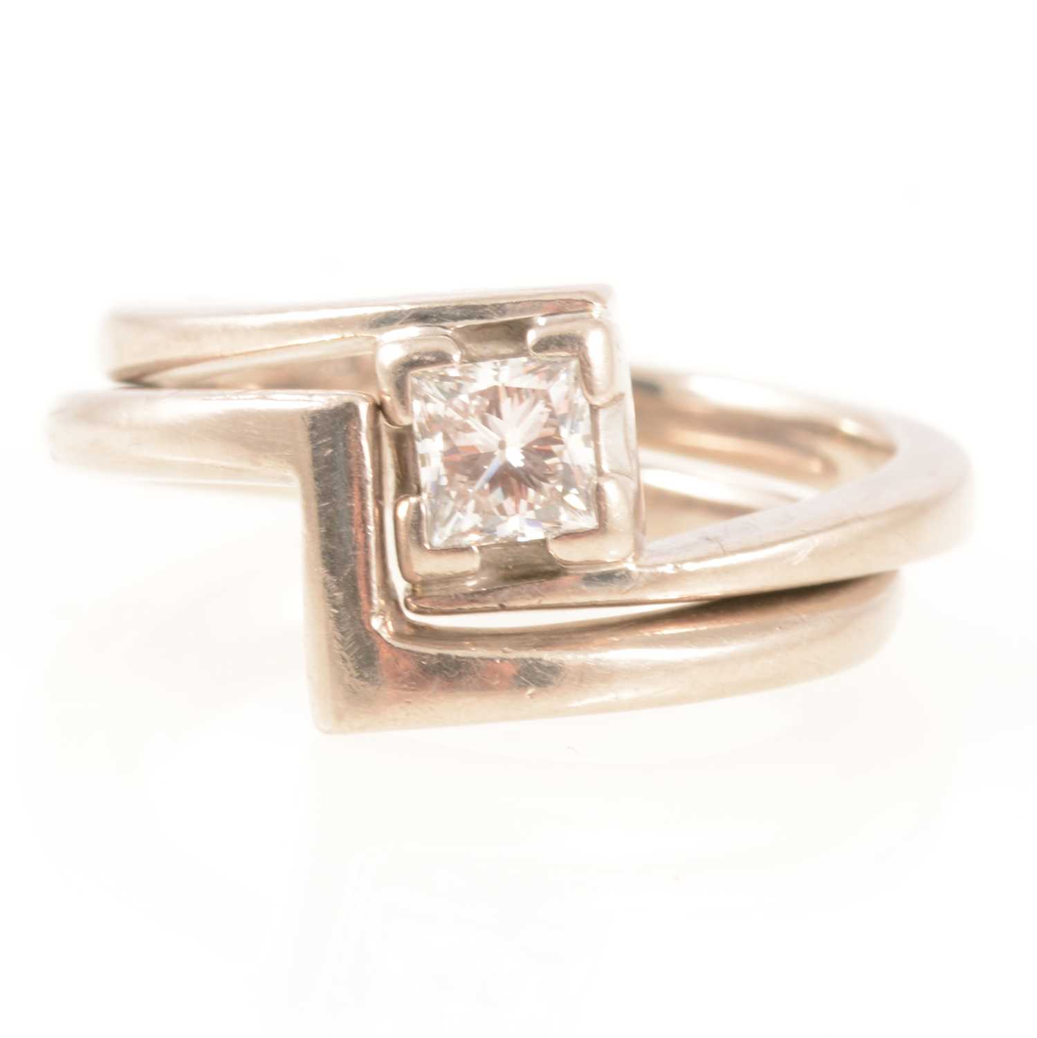 Lot 289 - A Princes cut diamond engagement ring and matching wedding ring.