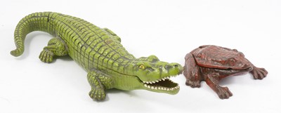 Lot 113 - Green cast iron crocodile and red frog smoking accessories.