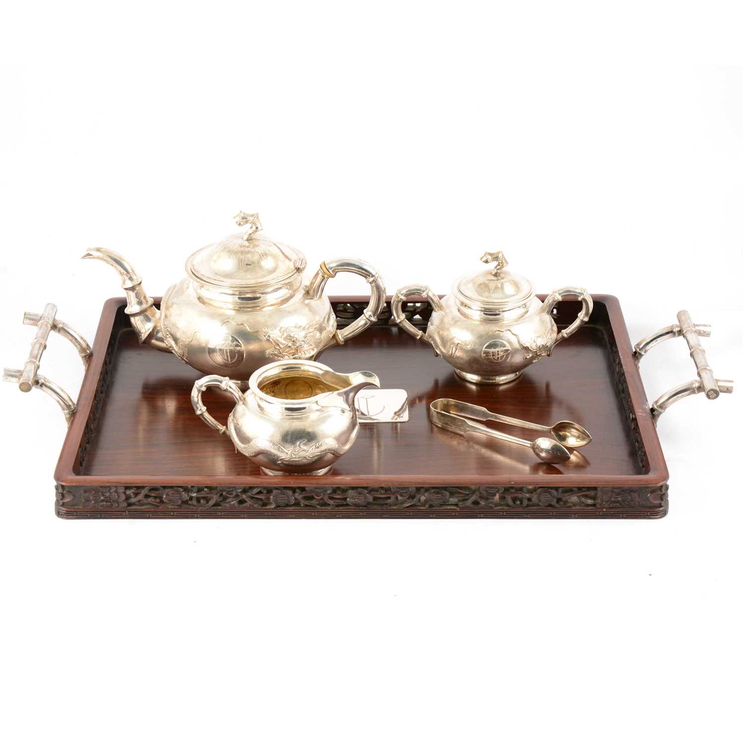 Lot 45 - Chinese silver three piece teaset with sugar tongs and a rosewood tray