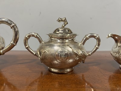 Lot 45 - Chinese silver three piece teaset with sugar tongs and a rosewood tray