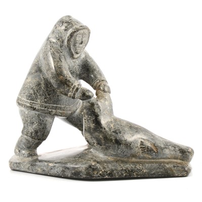 Lot 95 - Inuit carving of an Eskimo seal hunter and seal.