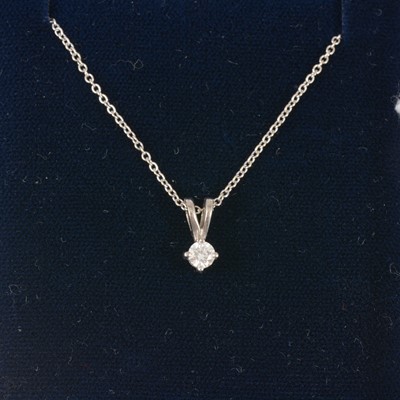 Lot 335 - A diamond single stone pendant and chain.