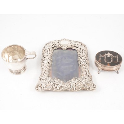 Lot 261 - Silver photograph frame, tortoiseshell and silver ring box, and christening mug.