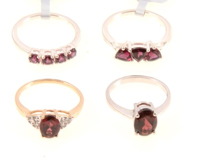 Lot 318 - Gemporia - Four garnet set rings.