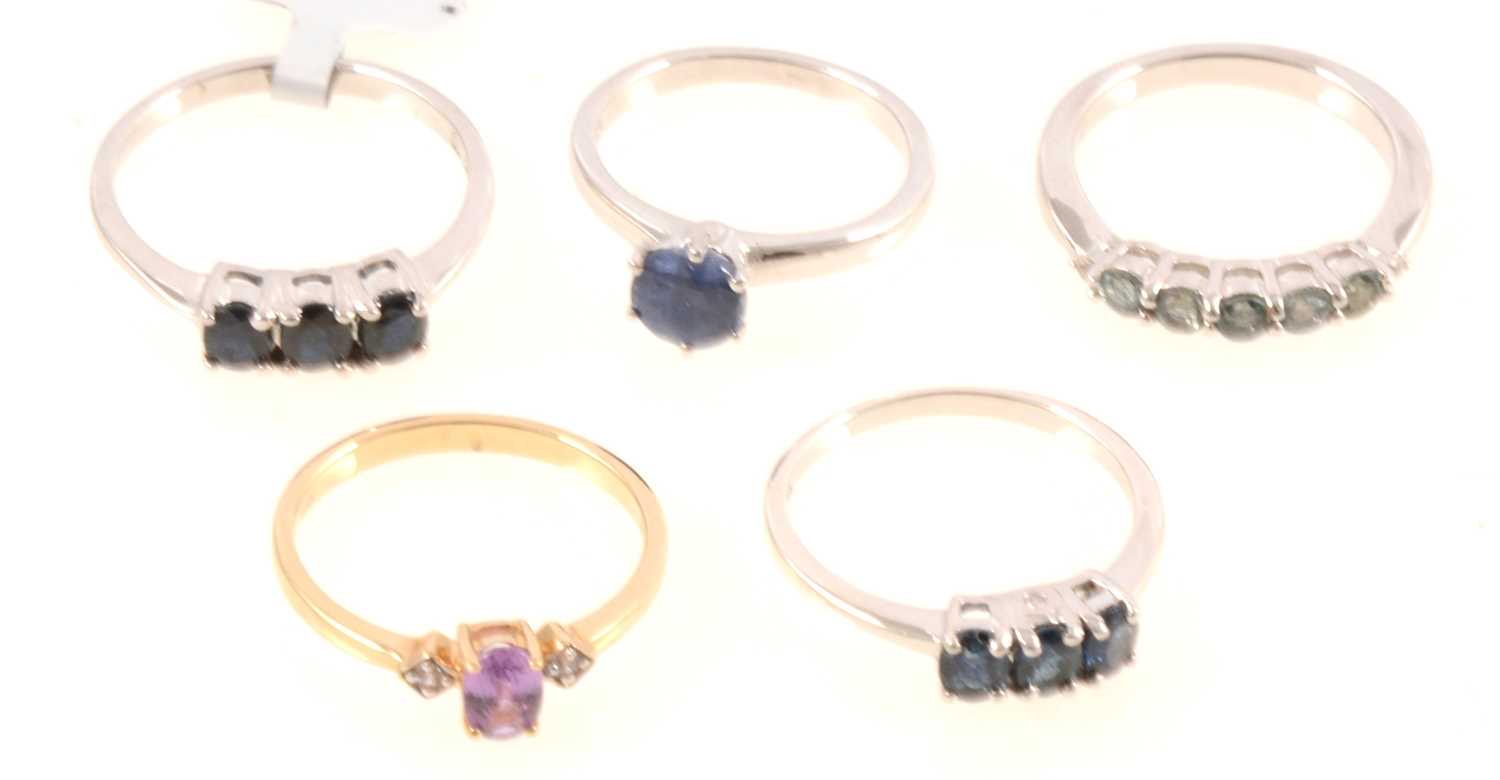 Lot 317 - Gemporia - Five sapphire set rings.