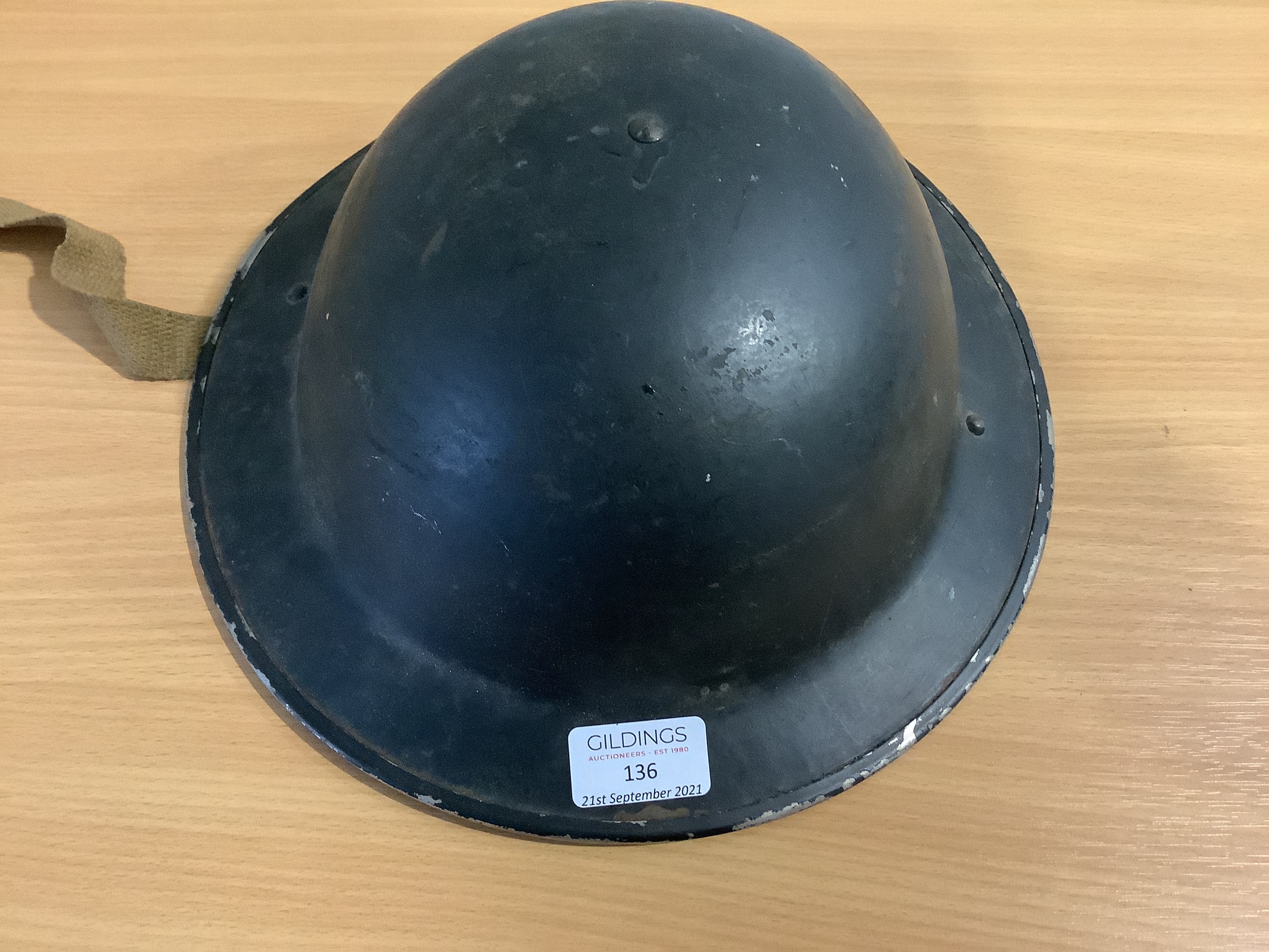 Lot 136 Three military tin helmets,