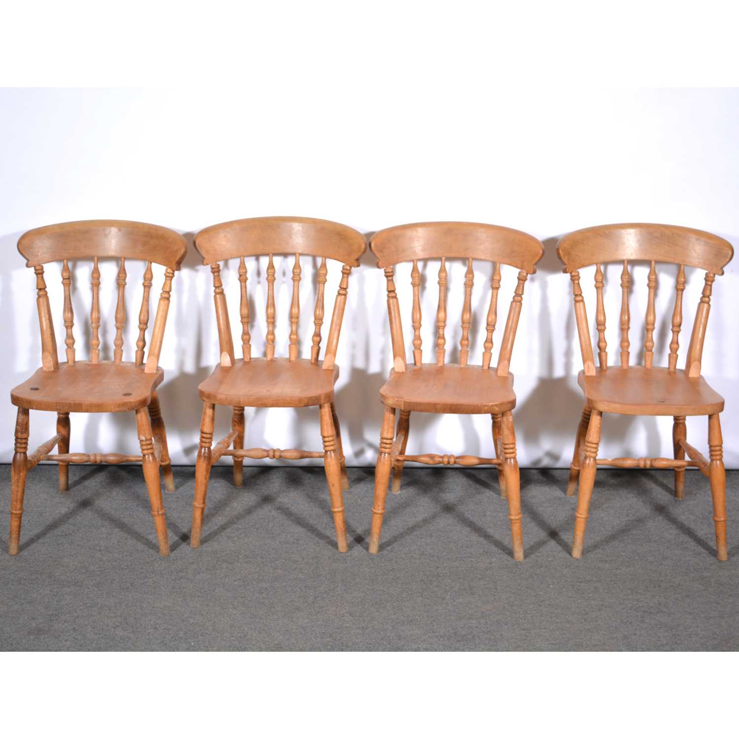 Lot 655 - Set of six stained beechwood spindle back kitchen chairs