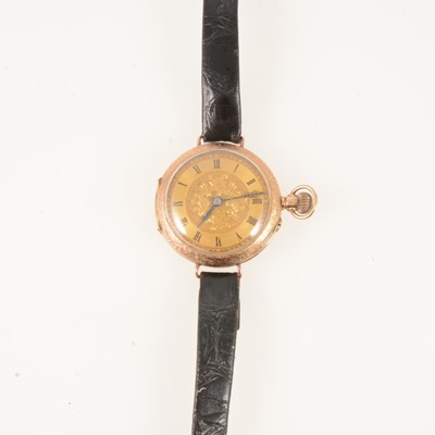 Lot 425 - A 12 carat yellow gold open face fob watch converted to a wristwatch.