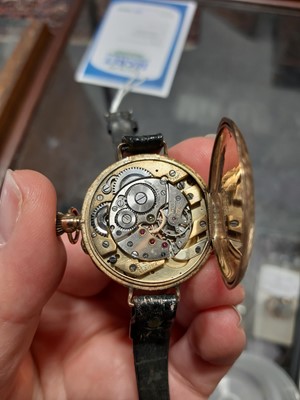 Lot 425 - A 12 carat yellow gold open face fob watch converted to a wristwatch.