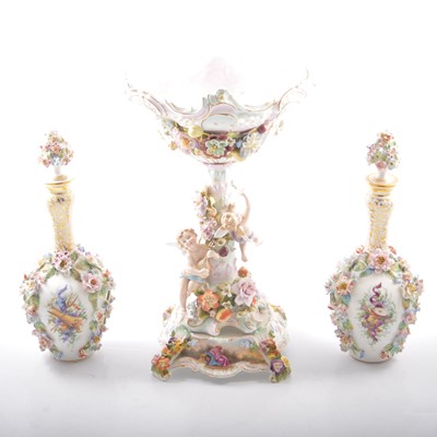 Lot 19 - A pair of floral encrusted bottle vases with stoppers, and a table centrepiece