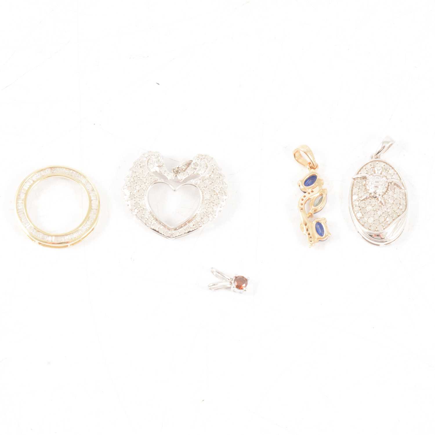 Lot 333 - Gemporia - Six diamond set pendants in 9 carat yellow gold and silver.
