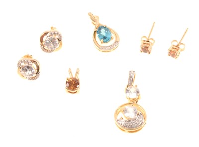 Lot 311 - Gemporia - Four zircon set pendants and two pairs of earrings in 9 carat yellow gold..