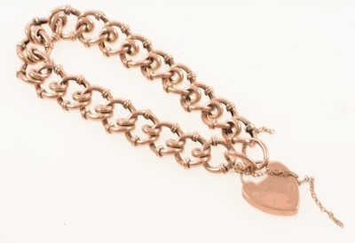 Lot 303 - A yellow metal hollow curb link bracelet with 9 carat padlock fastener.