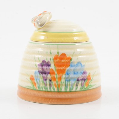 Lot 1018 - Clarice Cliff, a Crocus beehive preserve pot and cover, and an Aurea plate.