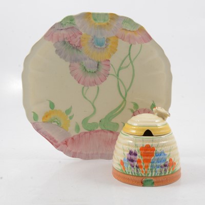 Lot 1018 - Clarice Cliff, a Crocus beehive preserve pot and cover, and an Aurea plate.