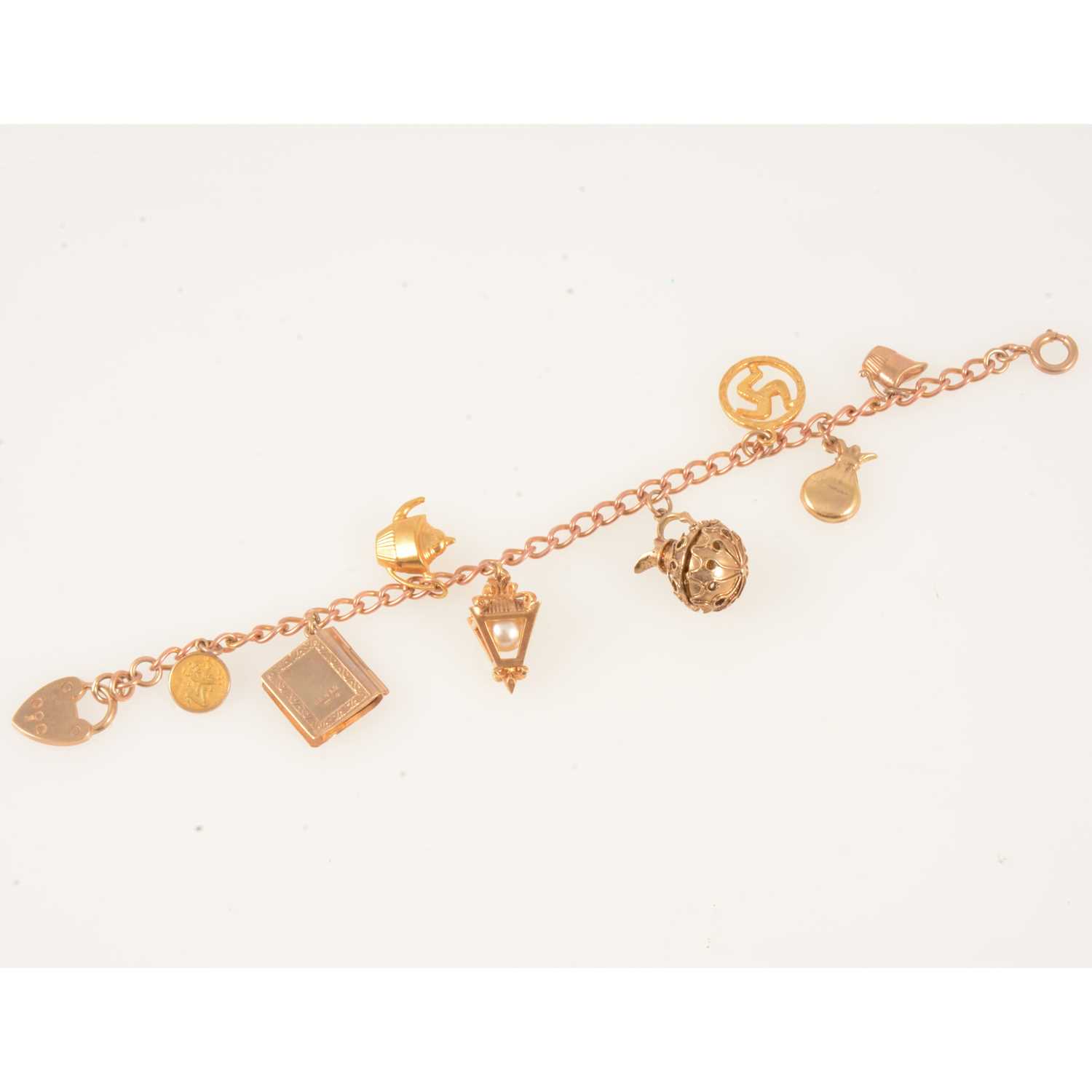 Lot 358 - A 9 carat rose gold charm bracelet with eight charms.