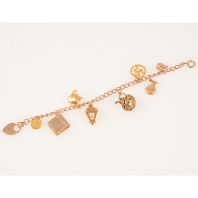 Lot 358 - A 9 carat rose gold charm bracelet with eight charms.