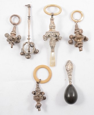 Lot 250 - Five silver rattles and a darning egg.