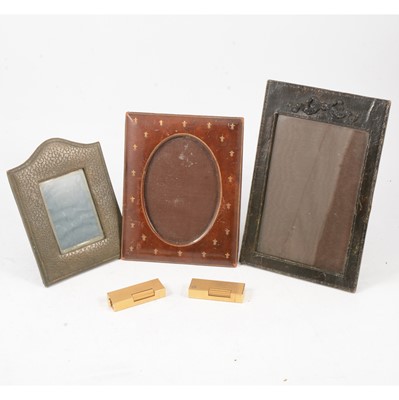 Lot 211 - Two Dunhill Swiss gold-plated cigarette lighters, and three leather photograph frames.