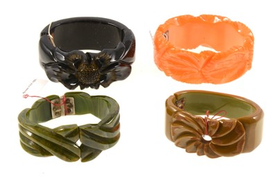 Lot 389 - Four American style bakelite hinged bangles, circa 1940's.