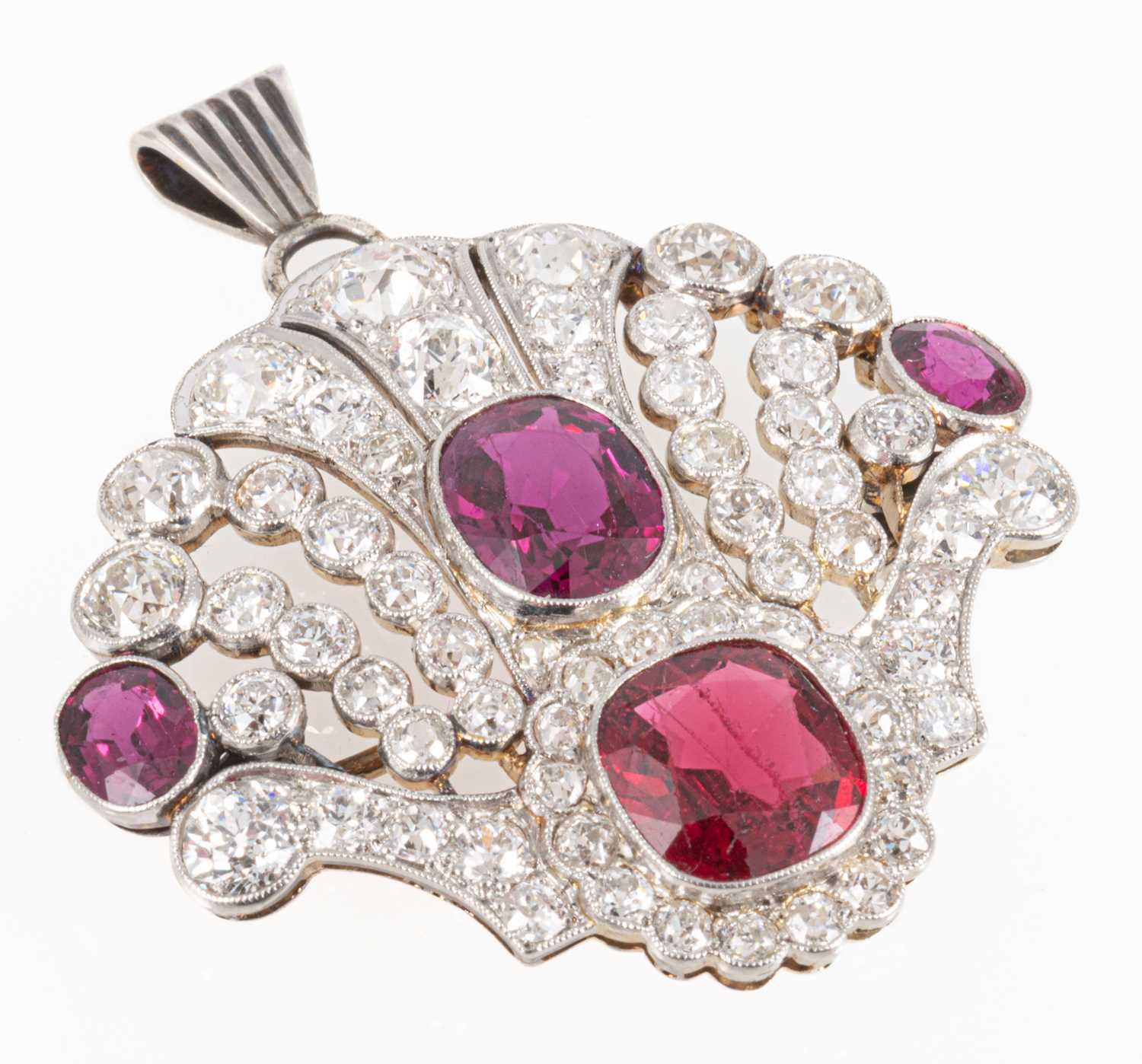 87 - An Edwardian style ruby, red spinel and diamond brooch/pendant.