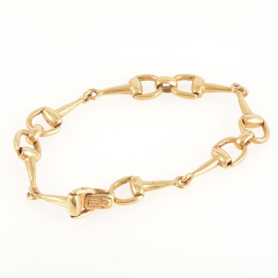 Lot 256 - An 18 carat yellow gold bridle bit bracelet.