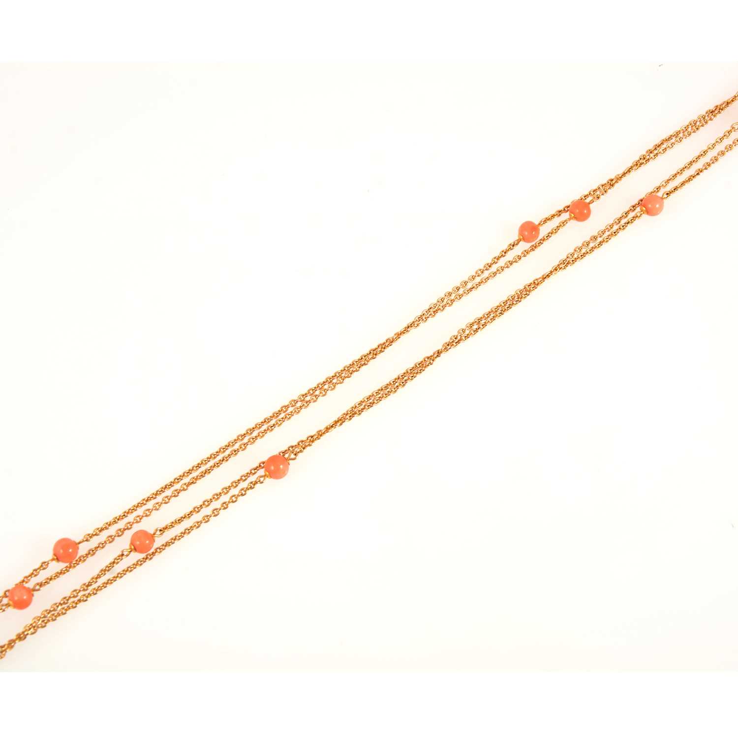 Lot 95 - A yellow metal guard chain set with coral beads with matching earrings.