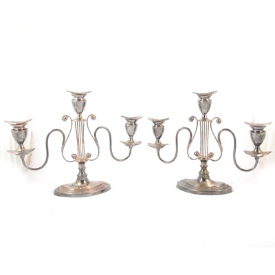 Lot 77 - Pair of Regency style silver plated three-light candelabra