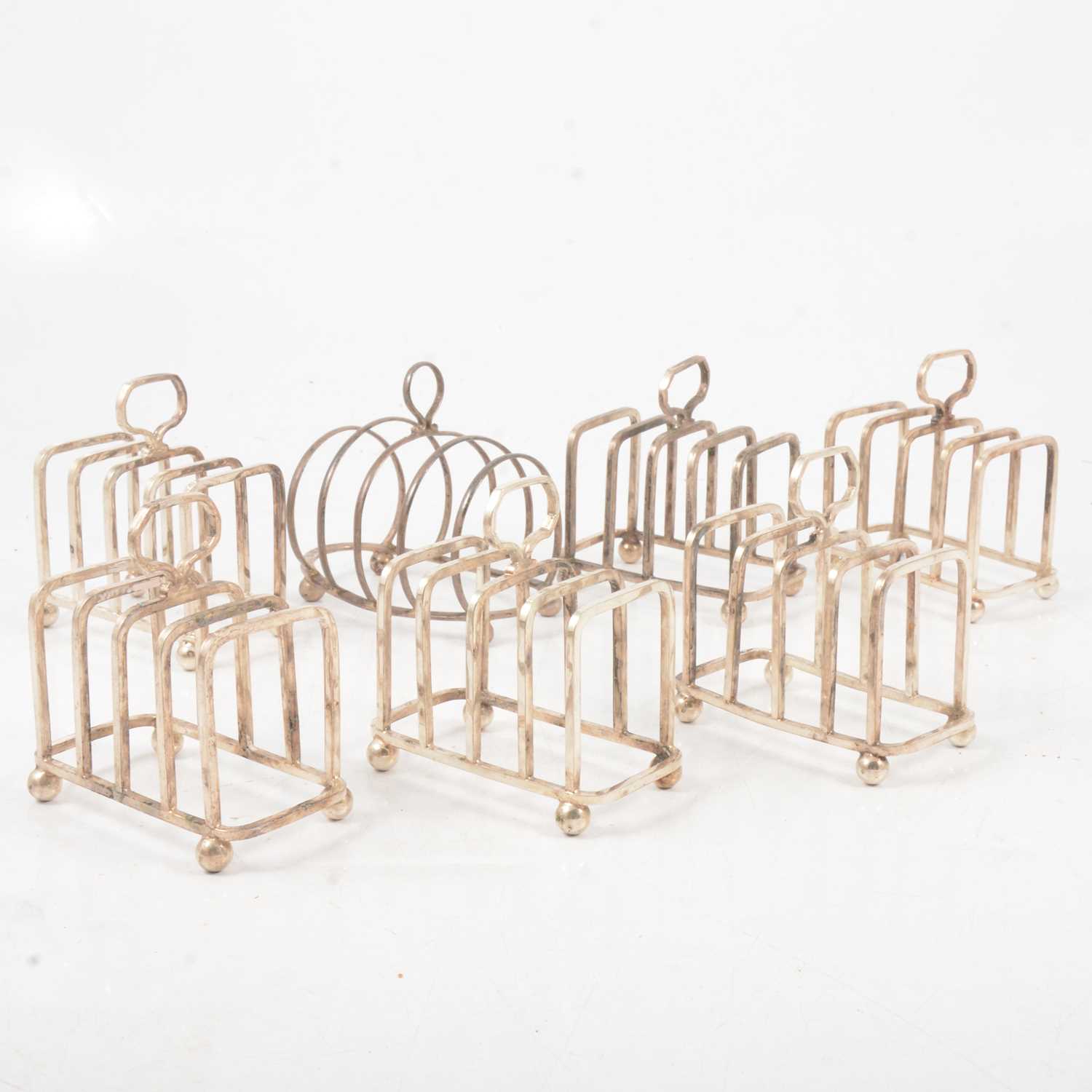Lot 197 - Silver toast rack and six silver plated toast racks