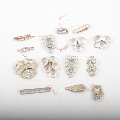 Lot 404 - Fourteen vintage paste set brooches and dress clips set with large brilliants.