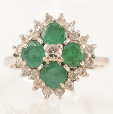 Lot 301 - An emerald and diamond cluster ring.