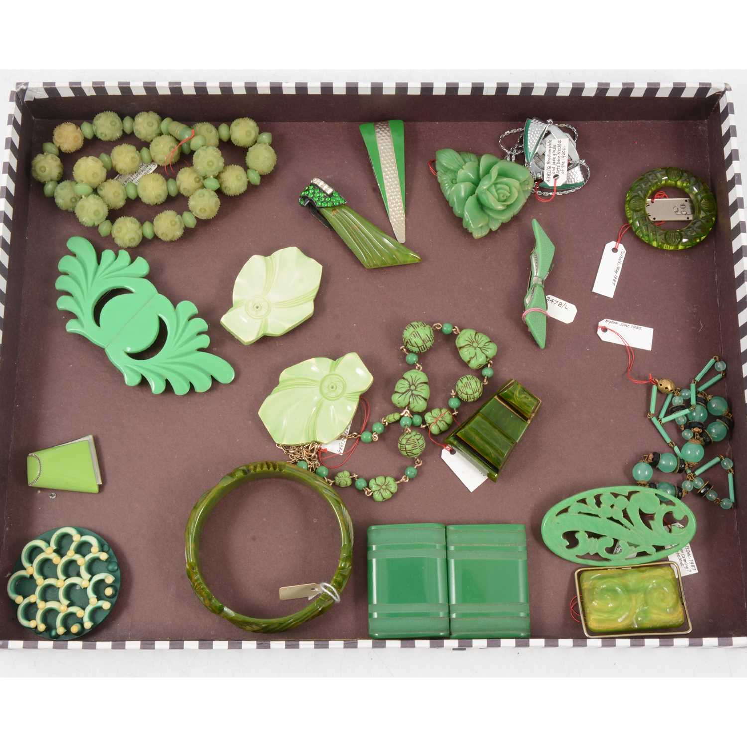 Lot 398 - One tray of vintage bakelite and celluloid jewellery with a green tone.
