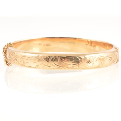 Lot 252 - A 9 carat yellow gold half hinged bangle.