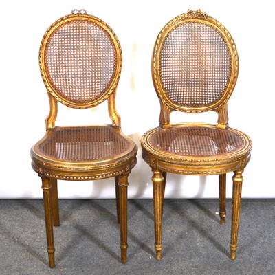 Lot 550 - Pair of French gilt wood and cane panelled side chairs