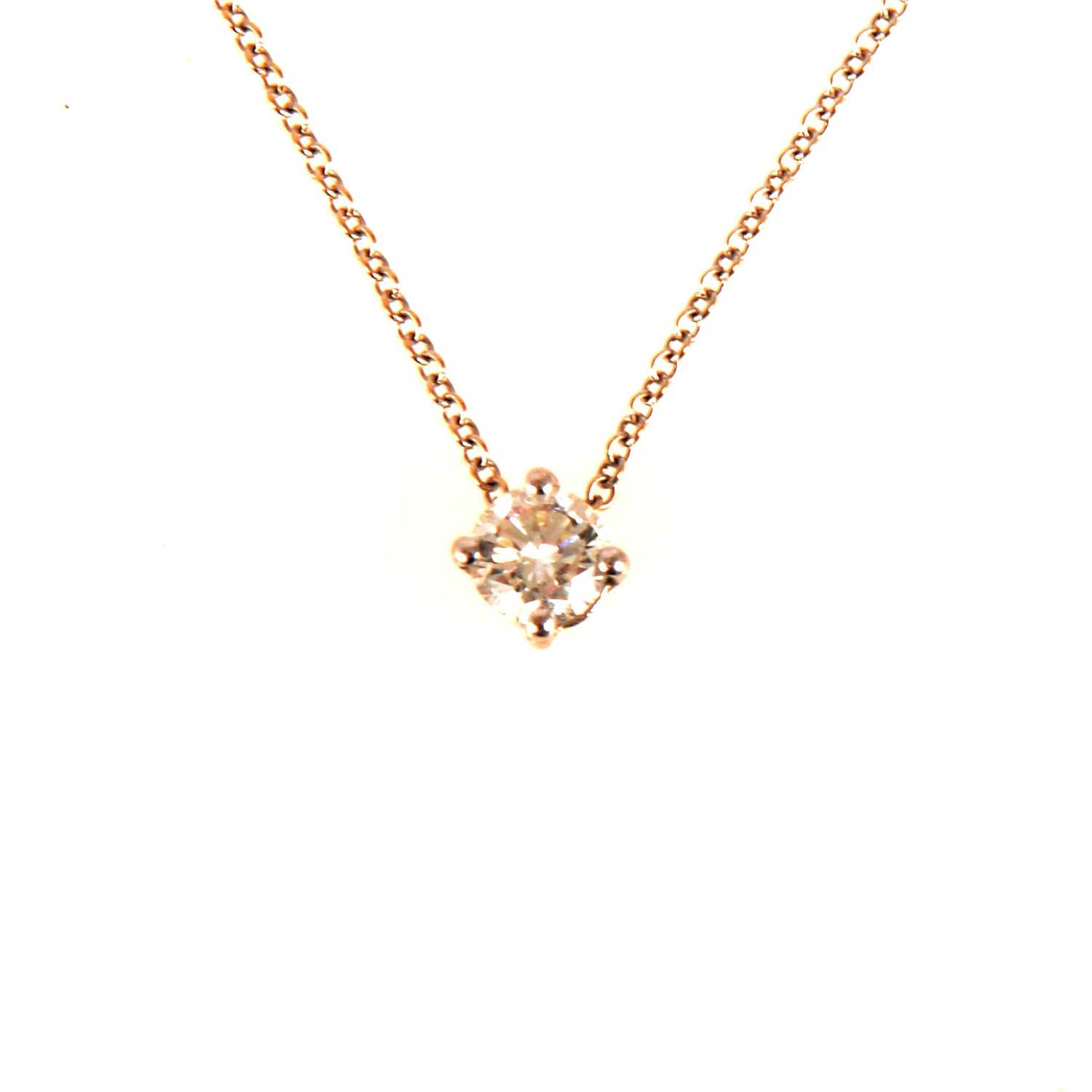 Lot 100 - A diamond solitaire pendant and chain.